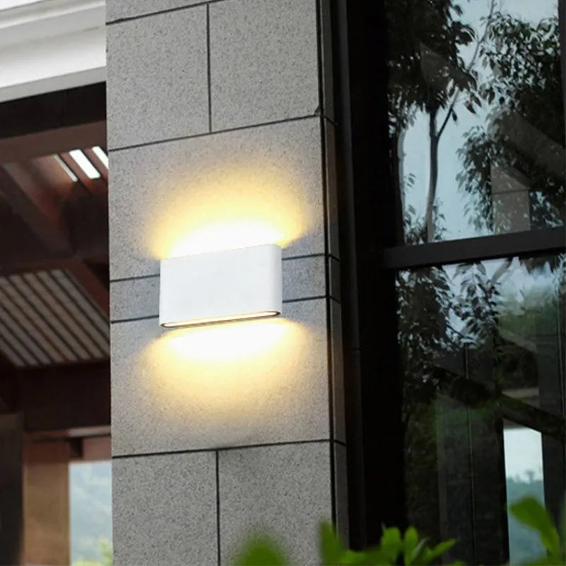 White up/down wall light on an outdoor stone wall