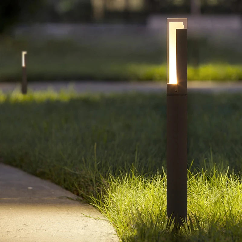 Square pillar path light lining a garden walkway