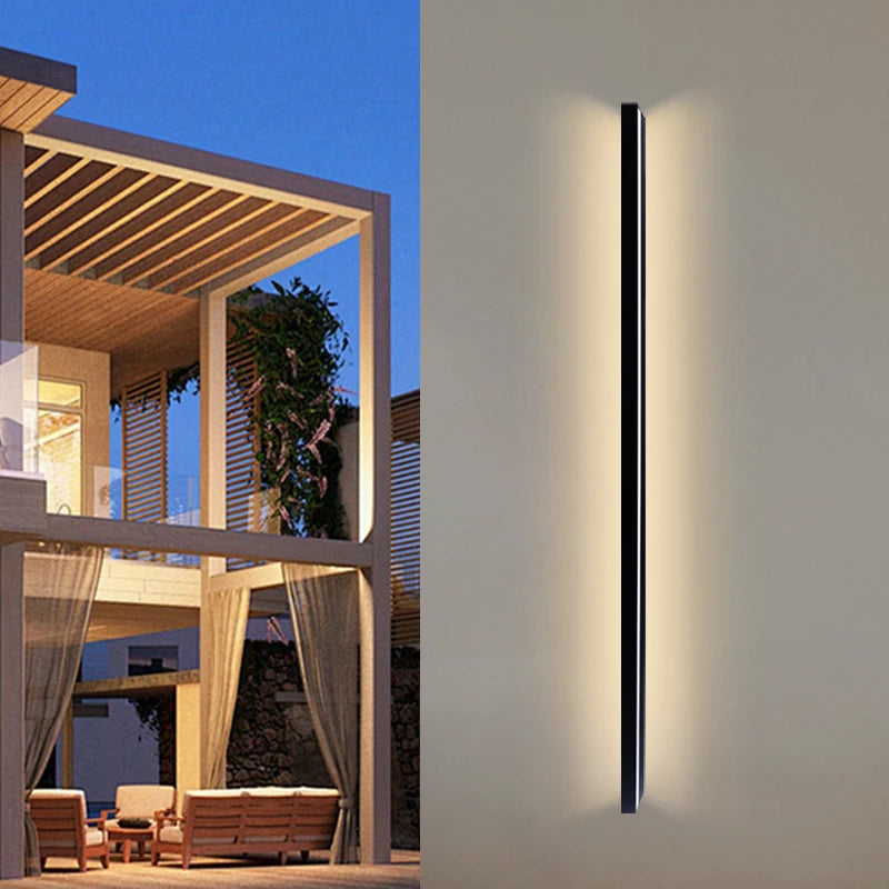 Vertical linear wall light beside a pergola at dusk