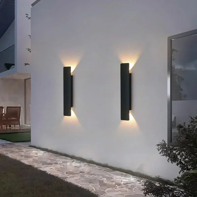 Pair of black up/down bar wall lights on a modern exterior wall